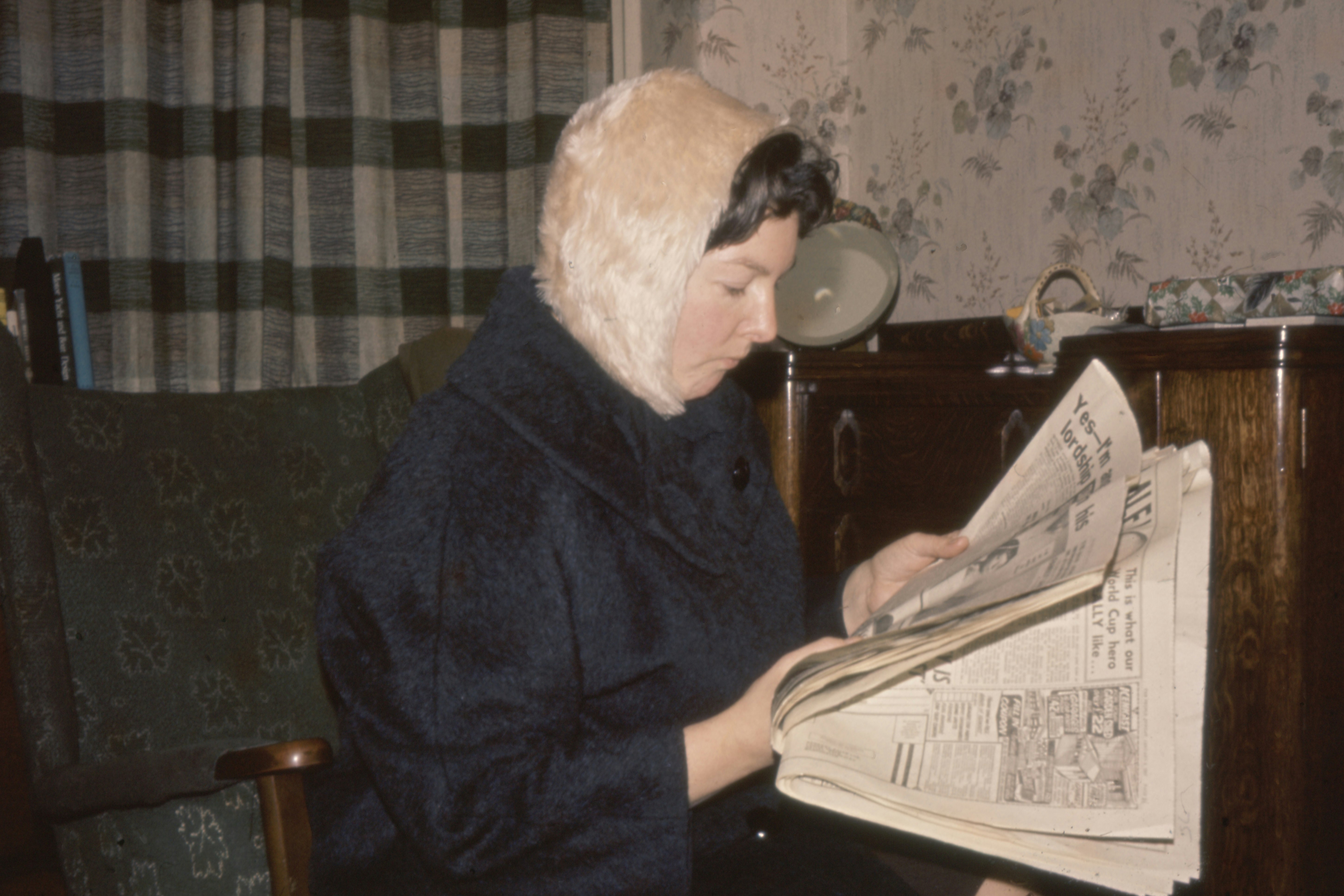woman holding newspaper